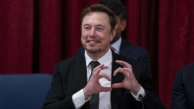 Elon Musk makes a heart with his hands during a Senate meeting on Artificial Intelligence.