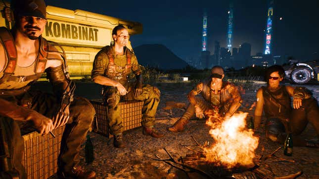 The nomads are shown gathered around a camp fire with Night City in the background.